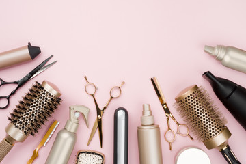 Various hair dresser tools on pink background with copy space