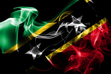 National flag of Saint Kitts and Nevis made from colored smoke isolated on black background