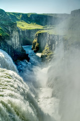 Fototapeta premium Gullfoss Waterfall Cascading Into a Misty Rocky Gorge in Iceland