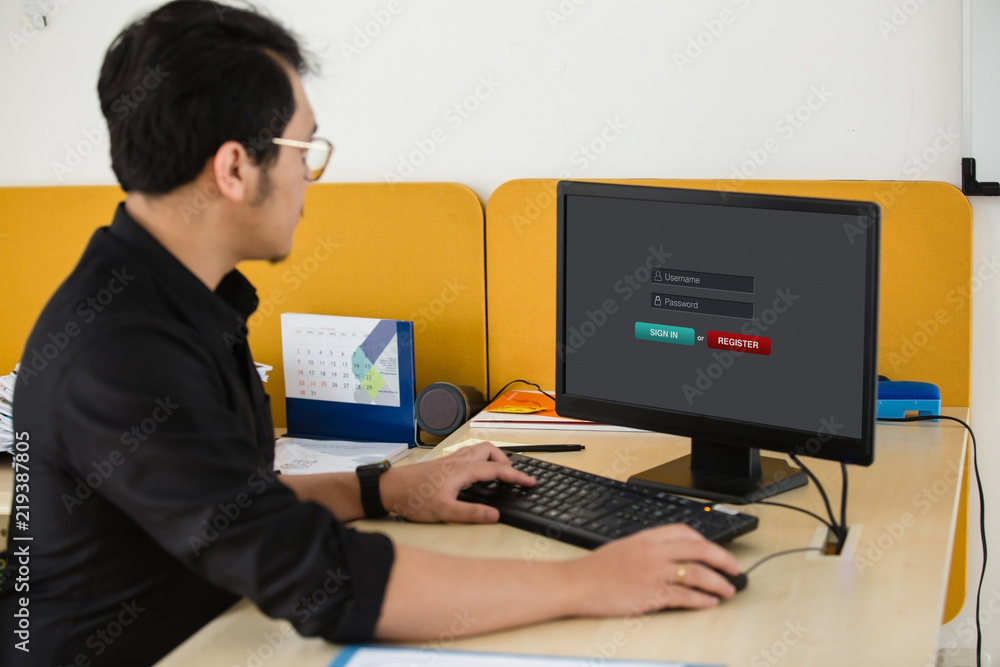 Poster man working and sign in membership username password on laptop / computer at office