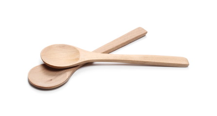 Empty wooden spoons isolated on white background