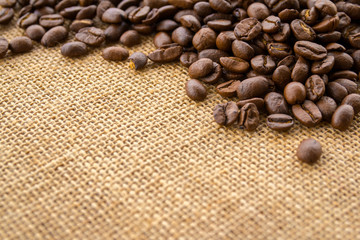 Coffee beans on burlap background