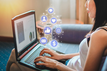 Asia woman using laptop for checking social media and success of business.Marketing and social media concept .