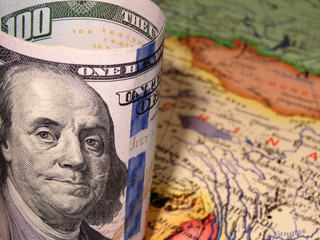 US dollars on the China map background, selective focus. Concept for trade war between the United States and China, chinese economy in terms of sanctions