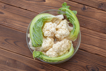 Organic cauliflower on wooden background