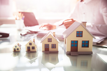 Increasing house models on reflective desk