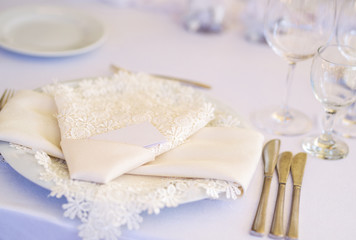 Fototapeta na wymiar Beautiful table set up - white cloth napkin and a plate 