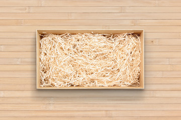 Fototapeta na wymiar Wine box with decorative filler on bamboo, top view