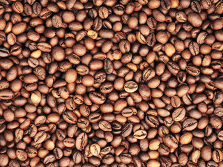 Roasted coffee beans background. Rich brown coffee beans texture. Close-up