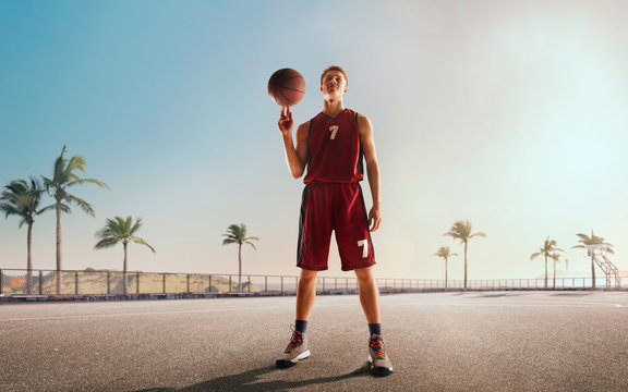 Streetball. Basketball player in action on sunset.