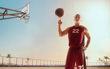 Streetball. Basketball player in action on sunset.