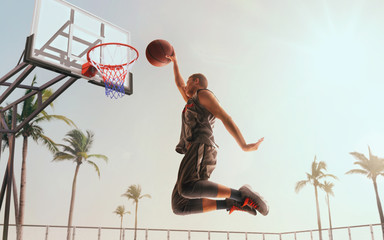 Streetball. Basketball player in action on sunset.