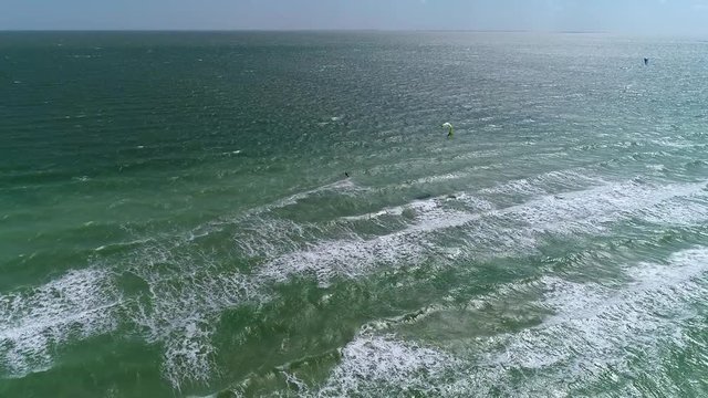 aerial shooting of a pair of kiters in the sea, slow motion