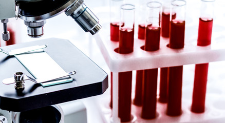 close up macro microscope with blood sample on white background
