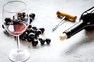 Glass of red wine and bottle on white background