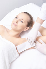 Fototapeta na wymiar Waxing woman leg. Sugar hair removal. laser service epilation. Salon wax beautician procedure