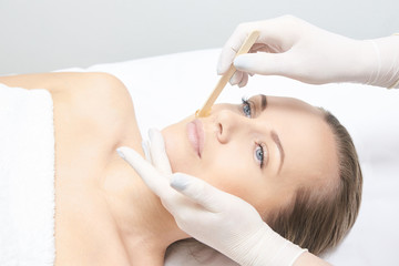 Obraz na płótnie Canvas Waxing woman leg. Sugar hair removal. laser service epilation. Salon wax beautician procedure