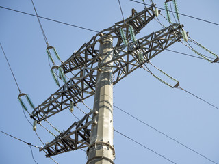 Large electric pole with wires on a blue sky background