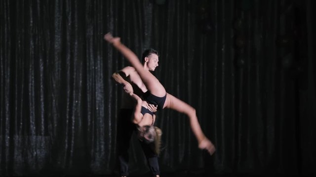 Professional dancers on stage performing show in slow motion