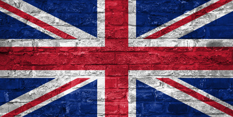 Fototapeta premium Flag of United Kingdom over an old brick wall background, surface