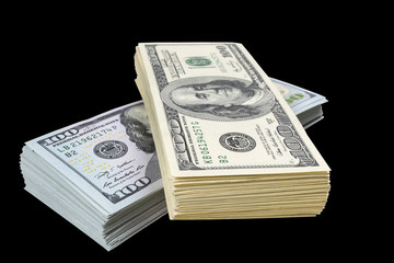 Stack of one hundred dollar bills isolated on black background. Stack of cash money in hundred dollar banknotes. Heap of hundred dollar bills background. Concept of financial success.