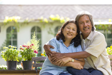 Love lives forever! Asian Senior couple  smiling in a garden on a sunny day. Happy Retirement Senior Lifestyle Living Concep