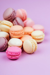 Obraz na płótnie Canvas Sweet french macarons on pink background.