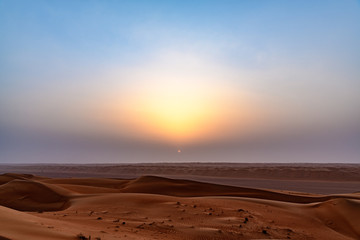Fototapeta na wymiar Wahiba Sands at sunrise in Oman. It is known as Sharqiya Sands or Ramlat al-Wahiba.