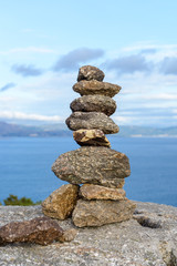 Fototapeta na wymiar stones on the shore built up by a pyramid