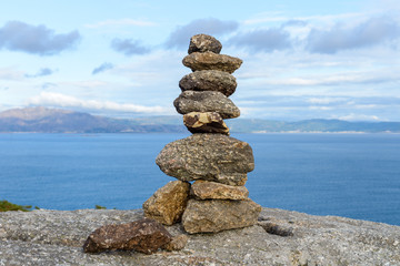 stones on the shore built up by a pyramid