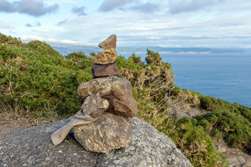 stones on the shore built up by a pyramid