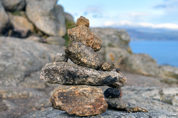 Fototapeta na wymiar stones on the shore built up by a pyramid