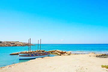 Beautiful Cypriot landscape by the sea with fishing boats in bright sunny day
