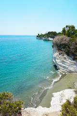 Beautiful view to the white cliffs and beach with black sand on the Governor Beach in Cyprus