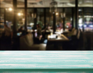 Wood table with blured background cafe , for your photo montage or product display. Space for placing items on the table.