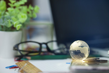 world or international concept with decoration glass globe on vintage office background.