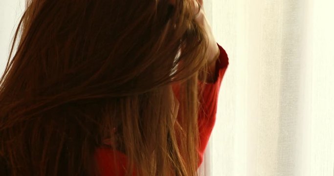 Woman is takling by smartphone