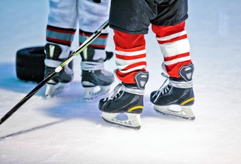 Naklejka premium Closeup of Child Legs in Ice Hockey in Arena