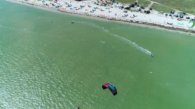View from the heights on the kiter that glides on the sea