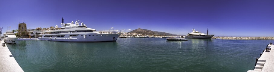 Fototapeta na wymiar Panorama of a huge yatch in Puerto Banus, a luxury harbour and marina in Marbella popular for the jetset