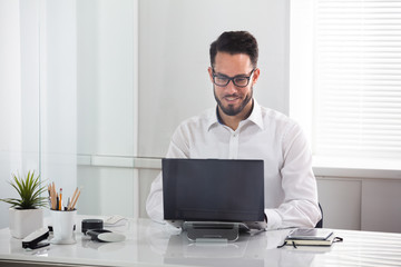 Fototapeta premium Smiling Businessman Using Laptop