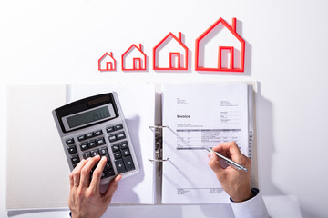 Businessperson Calculating Bill With Calculator