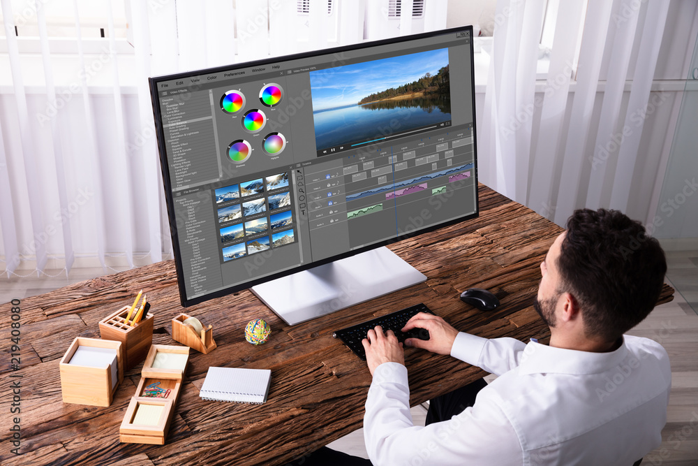 Poster editor editing video on computer
