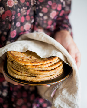 Woman holding Traditional Indian bread - Aloo paratha or aalu parotha, potato stuffed bread