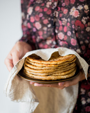 Woman holding Traditional Indian bread - Aloo paratha or aalu parotha, potato stuffed bread