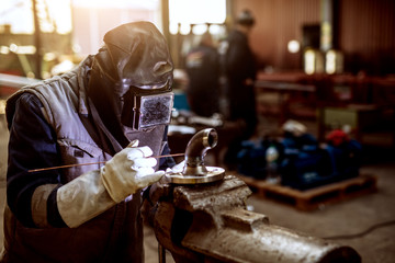 Close up of a male worker in protective uniform working on a new parts of machine.