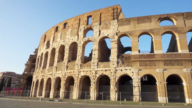Famous Italian attraction Colosseum in Rome. Veiw on ancient Flavius amphitheater Coliseum in capital of Italy. Camera moving from left to right