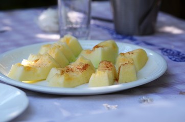 Melon with cinamon on  white plate