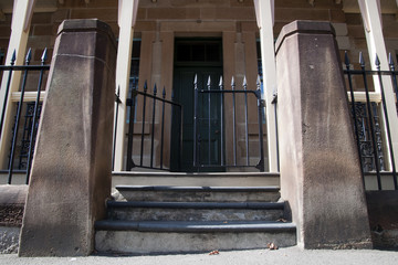 Sydney Australia,  Street entrance to old colonial building with wrought iron fence 