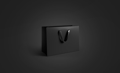 Blank black paper bag with silk handle mockup, isolated, pd rendering. Empty gift pack mock up. Carry shopping sack in darkness template